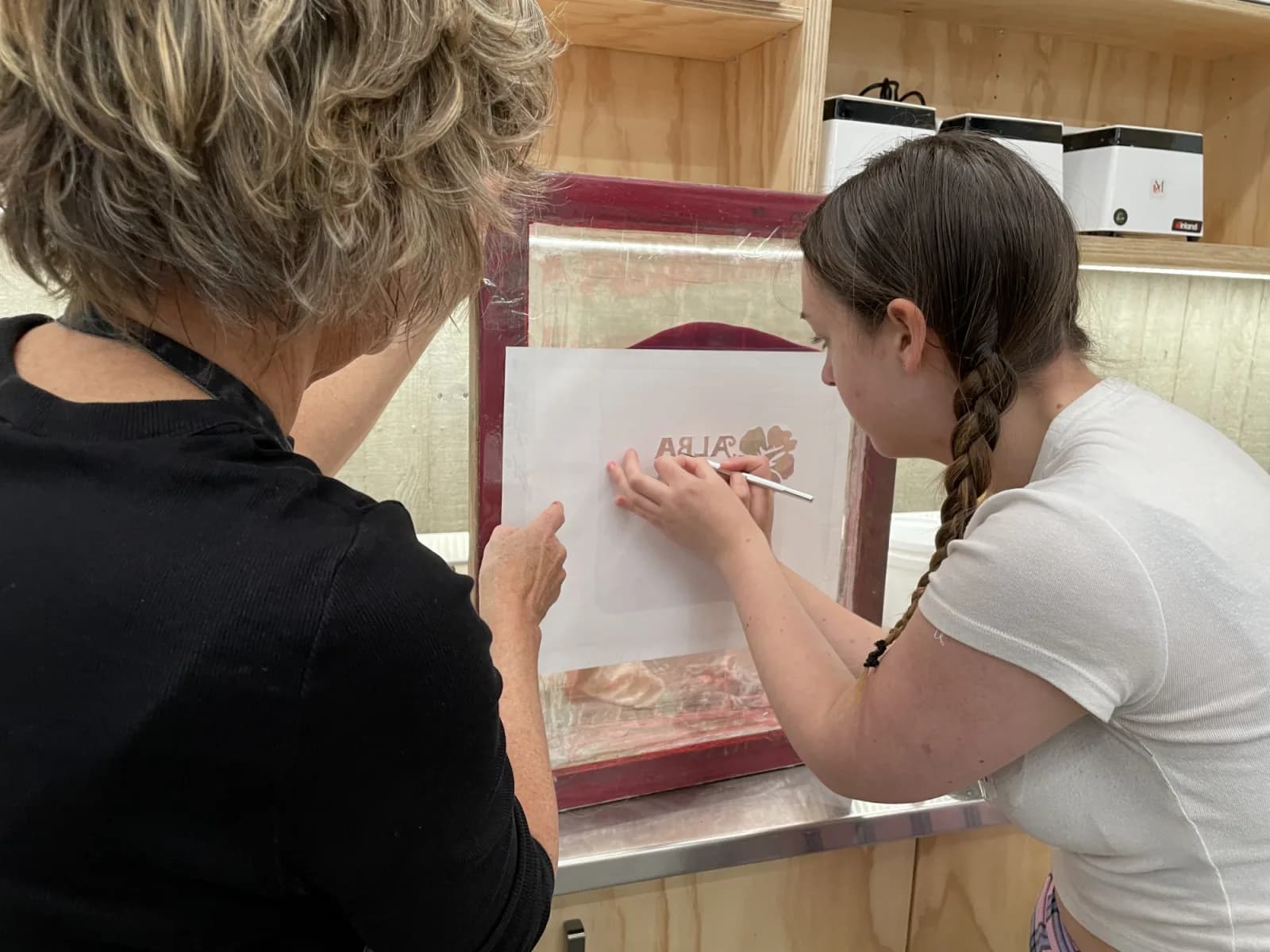 Instructor, Nicola Cerini, mentoring a participant in a screen printing workshop at the Rare Trades Centre.